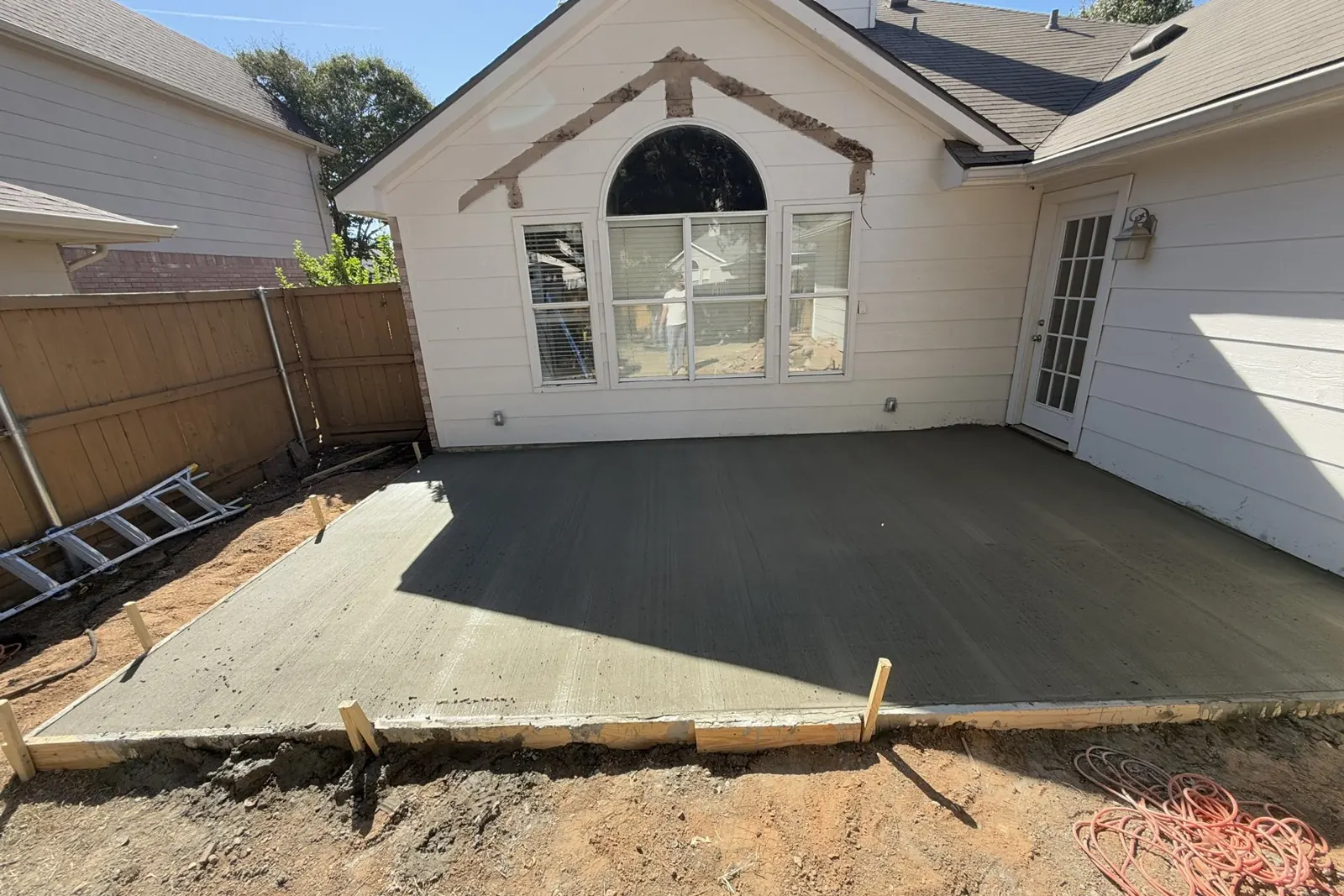Fresh concrete patio extension pour in McKinney