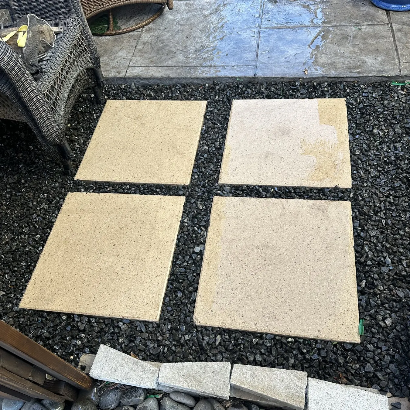 Concrete pavers set in gravel next to a stamped patio