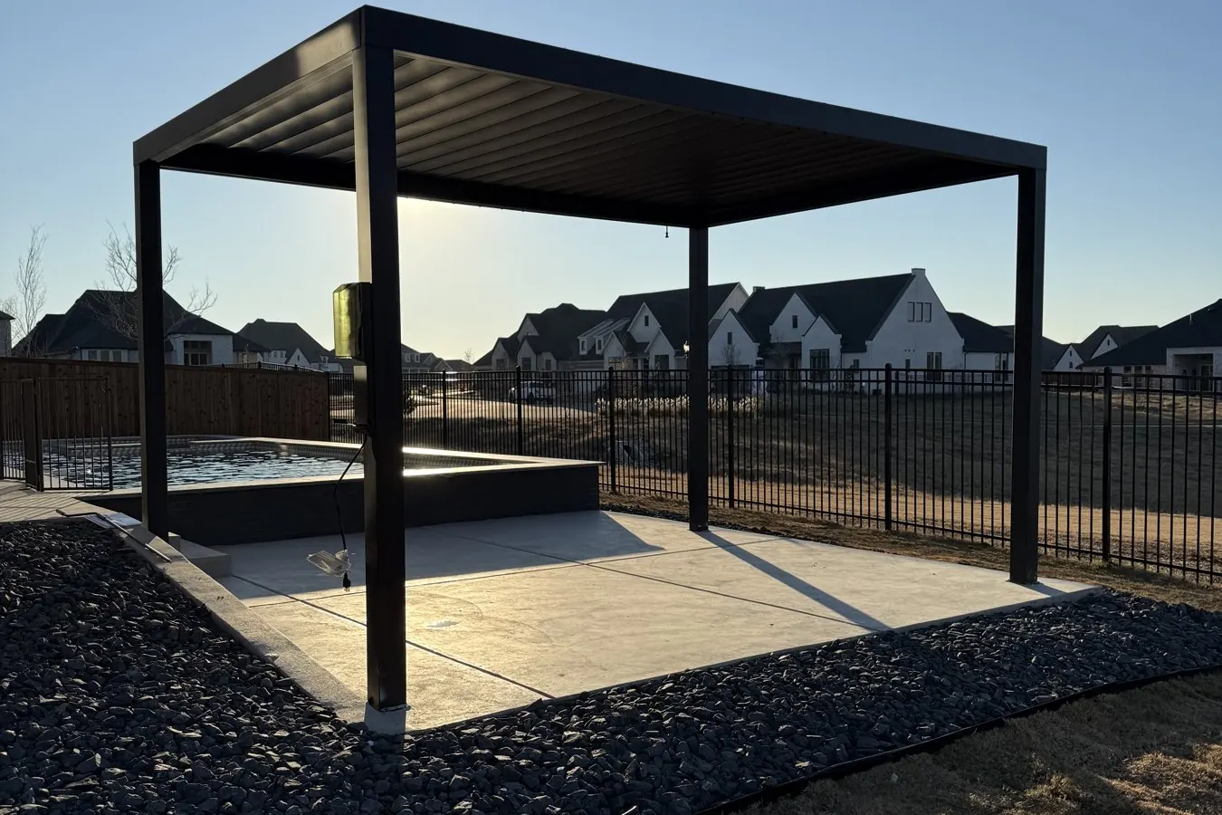 Concrete patio with pergola at sunset in Prosper