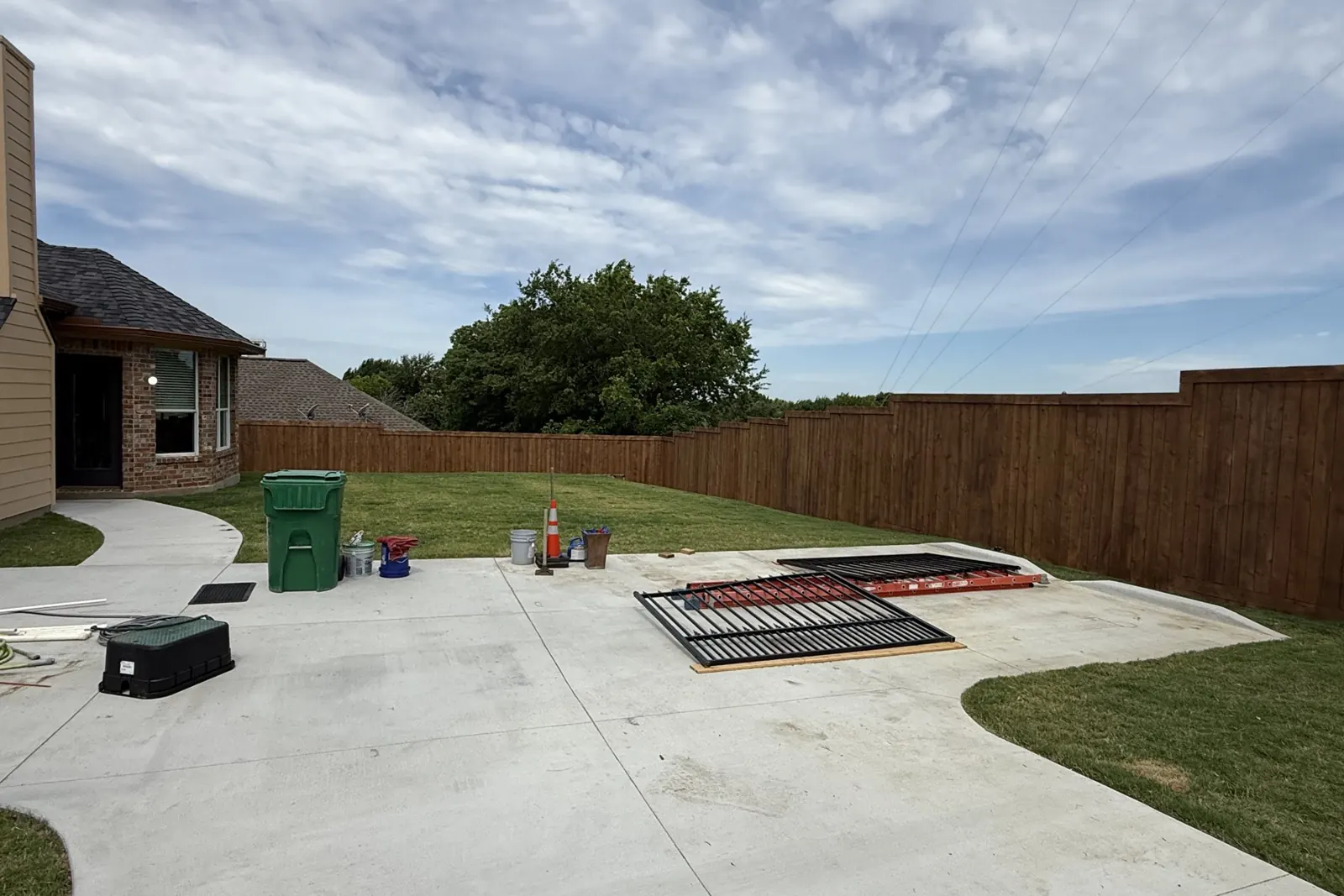 Stained cedar fence and lawn in Celina, TX