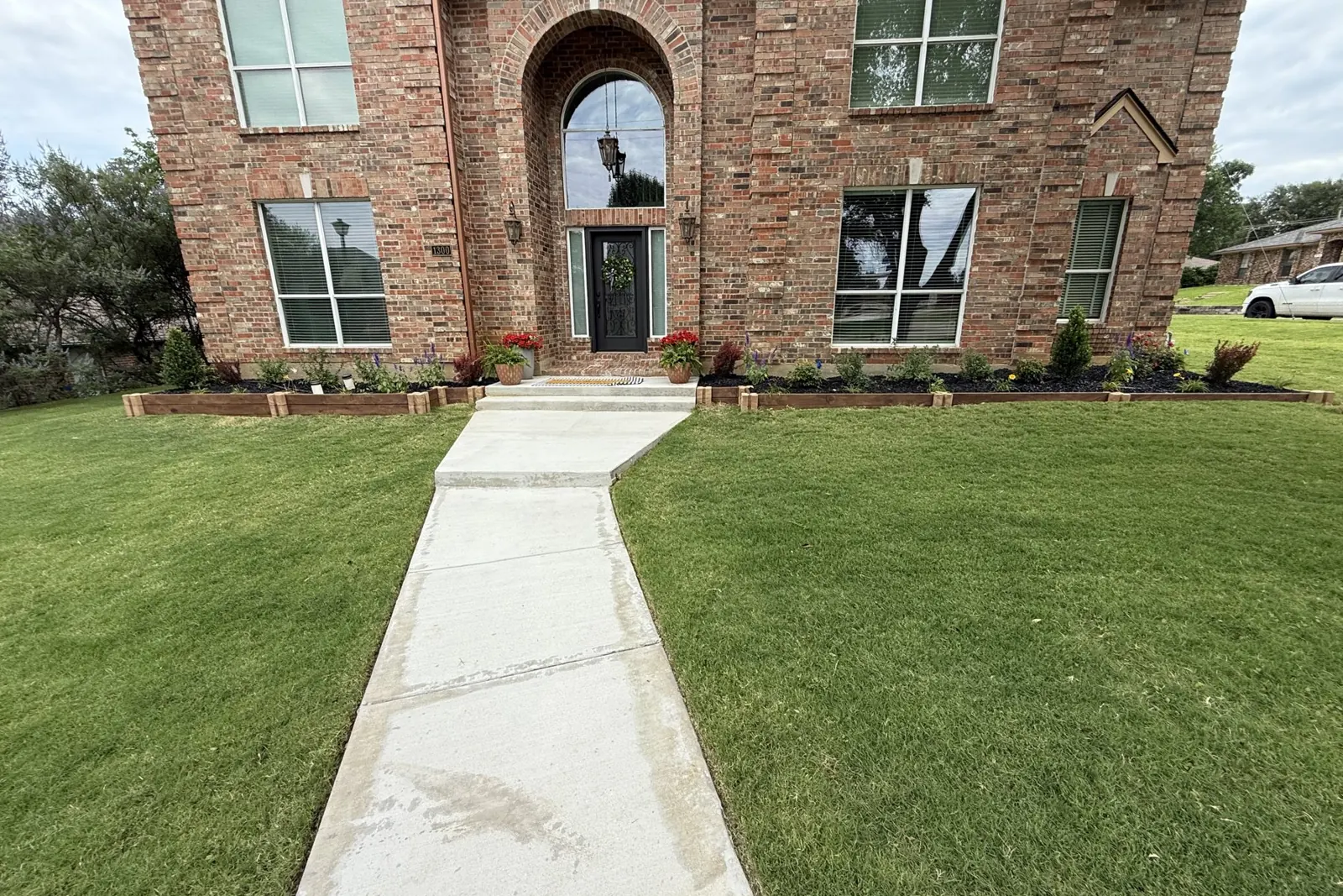 Healthy green front lawn with working irrigation in Prosper