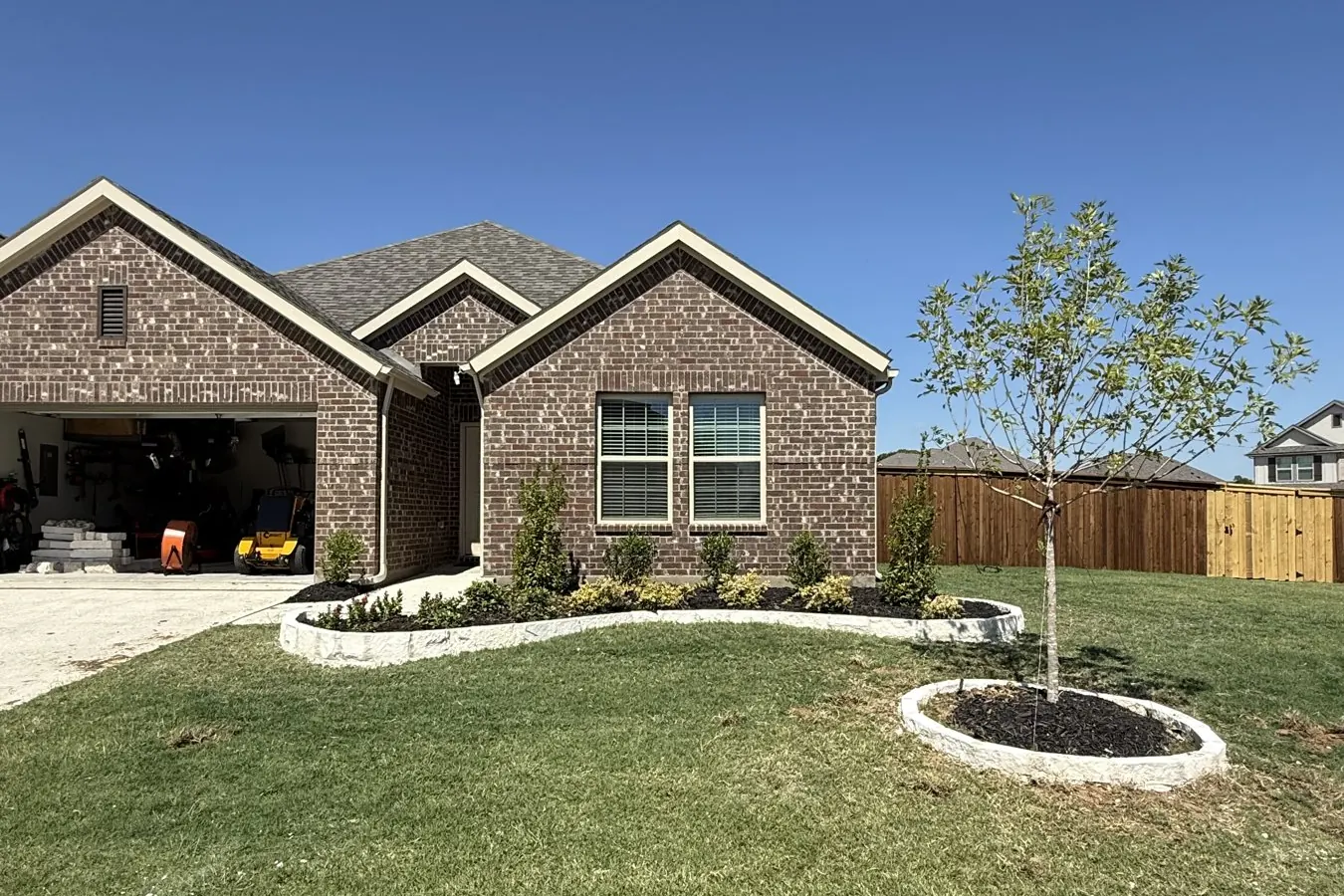 Front yard with stone bed edging and fresh sod