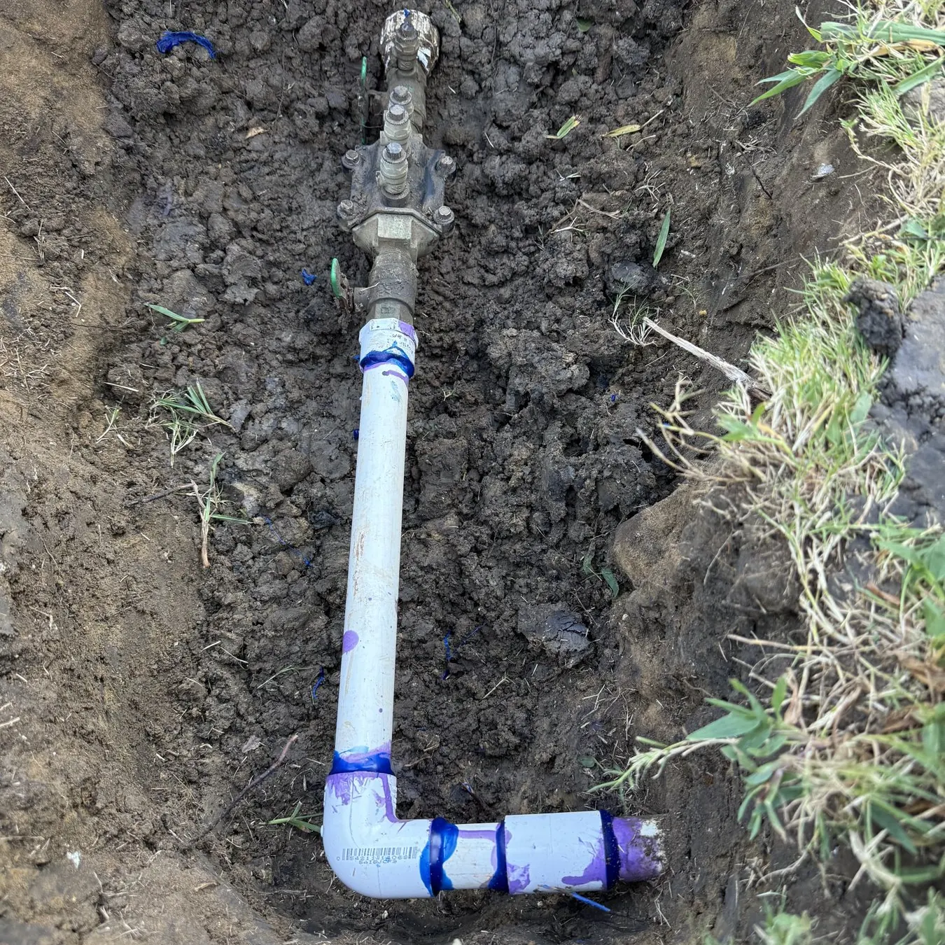 Sprinkler main line repair with new PVC fittings